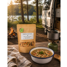 Load image into Gallery viewer, PureKtchn Barley Soup Mix served at a campsite with a campervan, portable stove and a bowl of freshly cooked barley soup