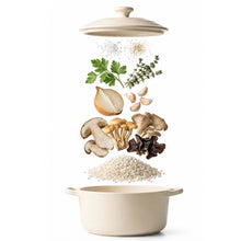 Load image into Gallery viewer, A cream-colored ceramic Dutch oven with lid is shown with its contents floating above: herbs, onion, garlic, mushrooms, and grains. The pot is centered on a clean white background.
